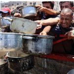 A crowd of people struggling to get some food in the Gaza Strip