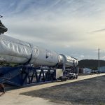 A semi-truck carrying what appears to be a rocket from the Australian space company