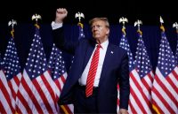 Donald Trump wearing an elegant suit, raising his right hand as a symbol of power