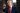 Donald Trump wearing an elegant suit, pointing forward with a very serious expression on his face