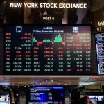 Some computers displaying on their screens the values, rises, and falls of global markets and currencies
