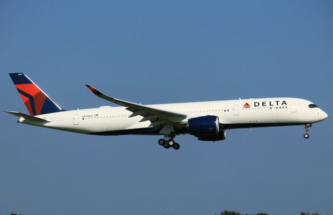 A Delta Airlines plane flying over the beautiful blue sky in the United States
