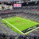 A large NFL team stadium packed with thousands of people