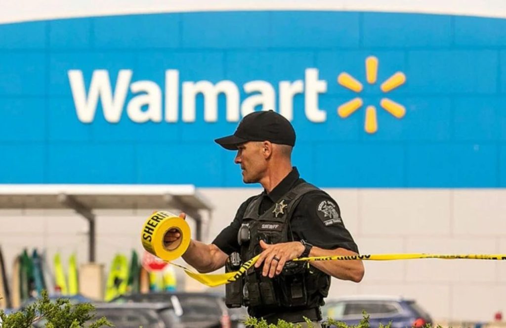 A police officer placing the security cordon in front of a Walmart