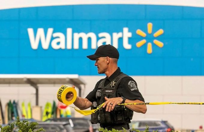 A police officer placing the security cordon in front of a Walmart