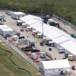 An aerial view of Alligator Alcatraz with several white tents