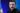 The Ukrainian president with long hair and a beard, staring intently at the audience while giving a speech