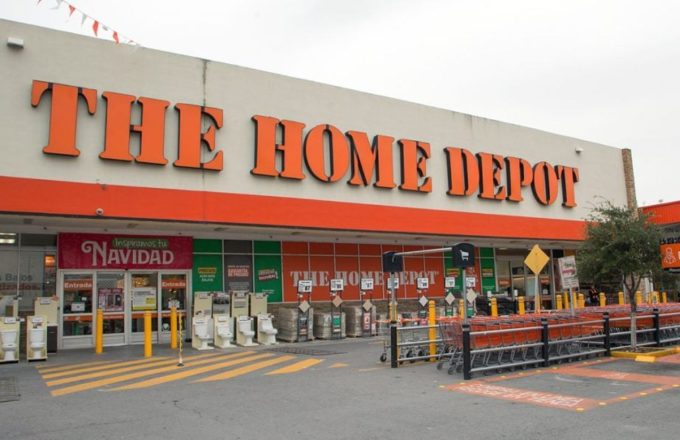 A branch of the well-known store with its orange letters, some shopping carts outside, and many signs on its windows