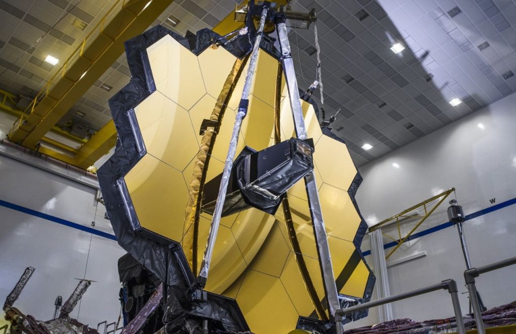 The high-tech telescope facing forward with its imposing golden lens