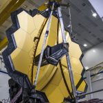 The high-tech telescope facing forward with its imposing golden lens
