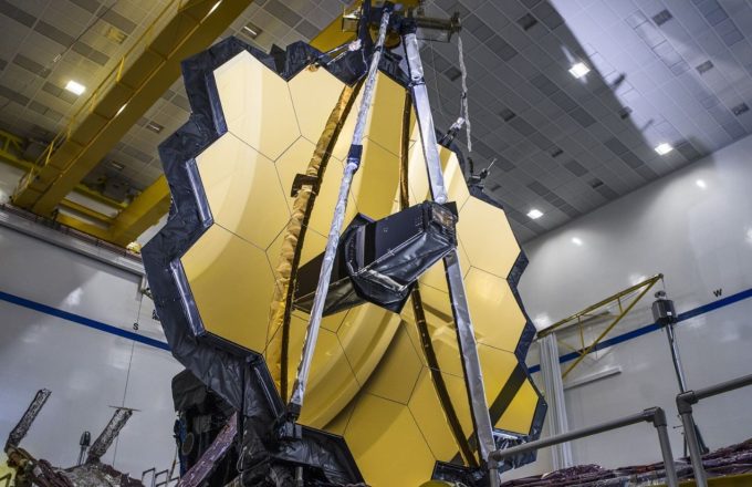 The high-tech telescope facing forward with its imposing golden lens