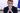 Emmanuel Macron sitting at his desk with his hands clasped in front of his nose
