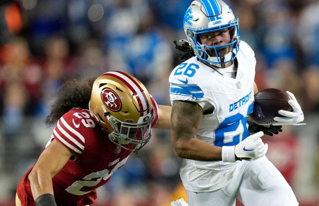 Two NFL players battling for the ball