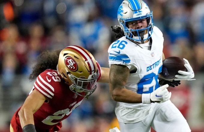 Two NFL players battling for the ball