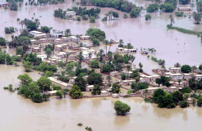 An aerial view of a Pakistani city with water reaching up to the rooftops due to flooding