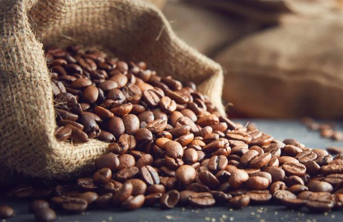 A sack full of coffee beans resting on the ground