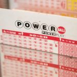 A Powerball lottery ticket with many numbers and letters