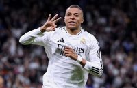 Mbappé celebrating a hat trick by holding up three fingers with his hand while running