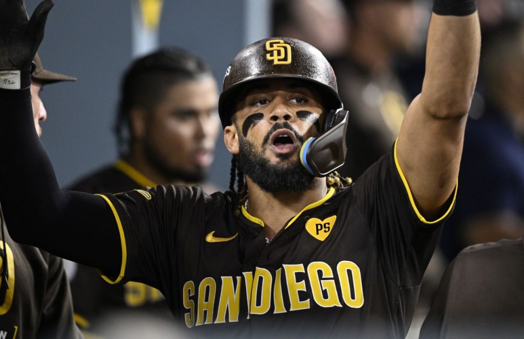 Fernando Tatis Jr. celebrating on the bench with his teammates