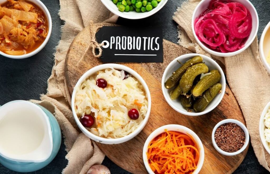 A kitchen table with some healthy foods and a small label on the side that says “Probiotics.”