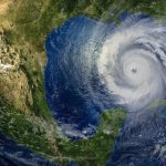An image of North America with a large hurricane or storm heading toward the continent