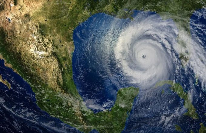 An image of North America with a large hurricane or storm heading toward the continent