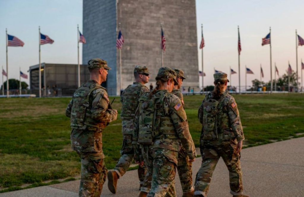 Several members of the National Guard patrolling the streets of Washington in their green military uniforms
