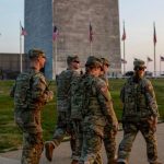 Several members of the National Guard patrolling the streets of Washington in their green military uniforms