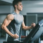 A man running on a treadmill in a gym