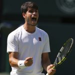 Carlos Alcaraz celebrating with euphoria a new title while holding his racket tightly