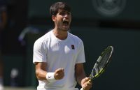 Carlos Alcaraz celebrating with euphoria a new title while holding his racket tightly