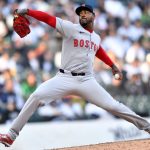 Aroldis wearing the white uniform with red socks and a red cap of the Red Sox