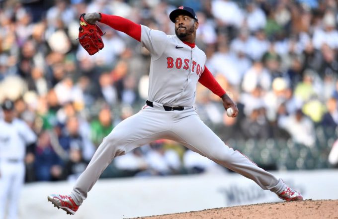 Aroldis wearing the white uniform with red socks and a red cap of the Red Sox