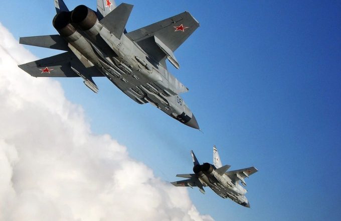 Two state-of-the-art Russian warplanes in gray, with red stars on their tails and wings