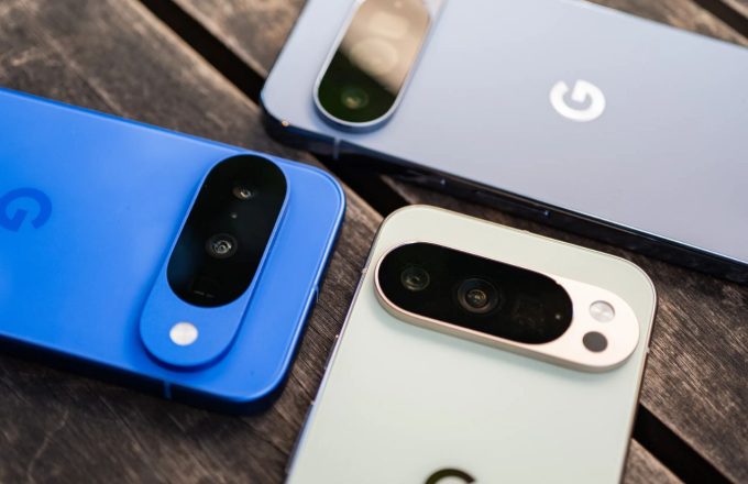 Three Pixel 10 smartphones in blue, white, and gray, placed face down on a table