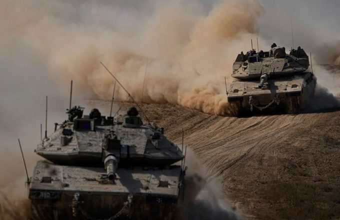 Two war tanks speeding through the vast Middle Eastern desert