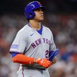 Juan Soto looking sad as he walks out of the batter’s box wearing his gray uniform with blue and orange accessories