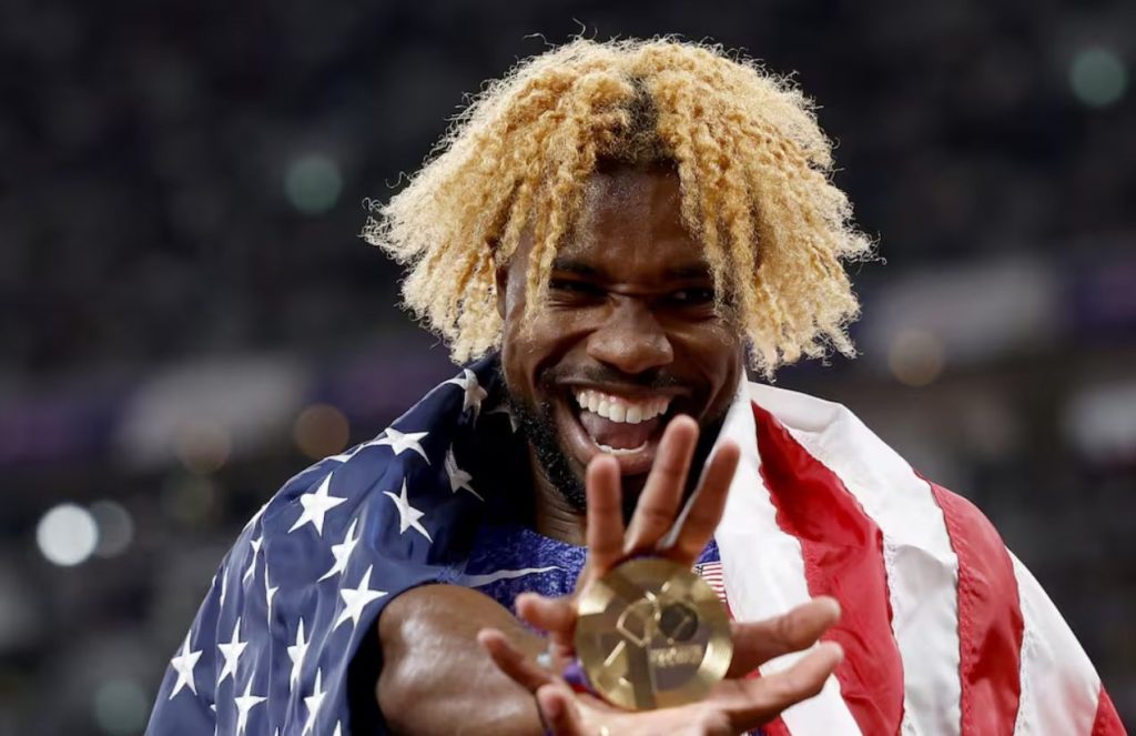 Noah Lyles regains the 200m throne lost in Paris The American runner with wild blond hair celebrating with his gold medal in hand