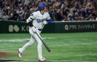 The South Korean player watching as the ball he just hit flies out of the field