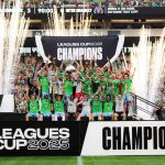 The Seattle Sounders team lifting the trophy in the middle of the field in front of all their fans