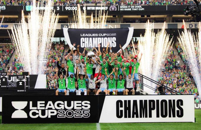 The Seattle Sounders team lifting the trophy in the middle of the field in front of all their fans