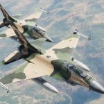 Two Venezuelan F-16s in camouflage flying across the wide blue sky