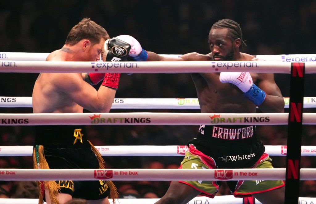 Canelo taking a punch from Terence Crawford inside the boxing ring