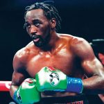 The famous boxer in a fighting stance in the middle of the ring