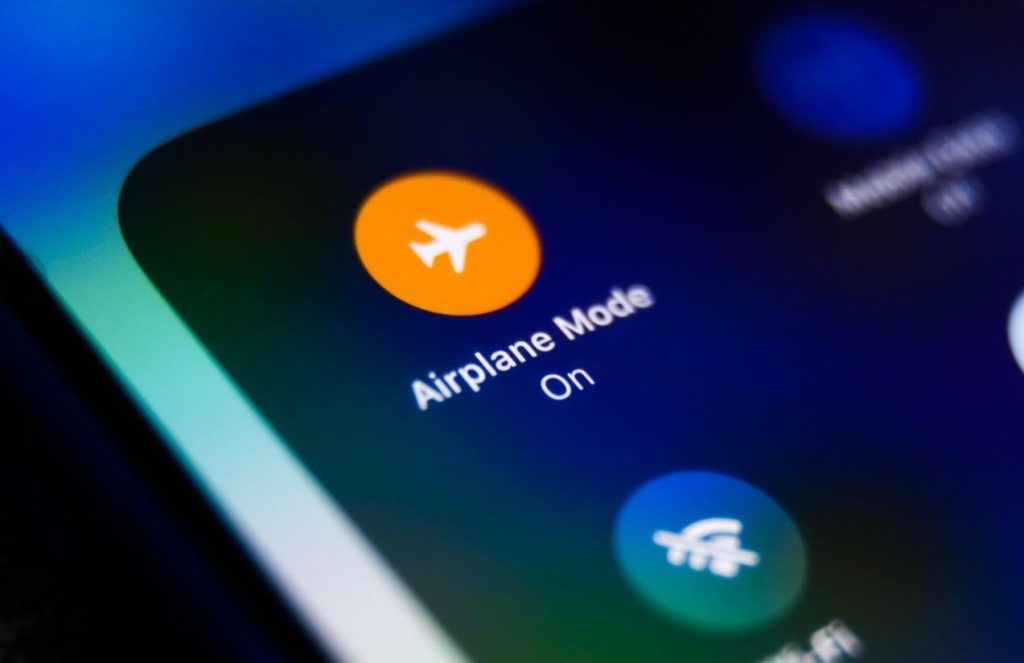 The orange airplane mode icon on a cell phone