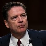 The former FBI director with a very serious expression, wearing a very elegant suit