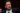 The former FBI director with a very serious expression, wearing a very elegant suit