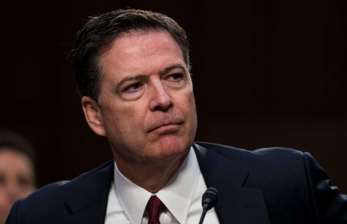 The former FBI director with a very serious expression, wearing a very elegant suit