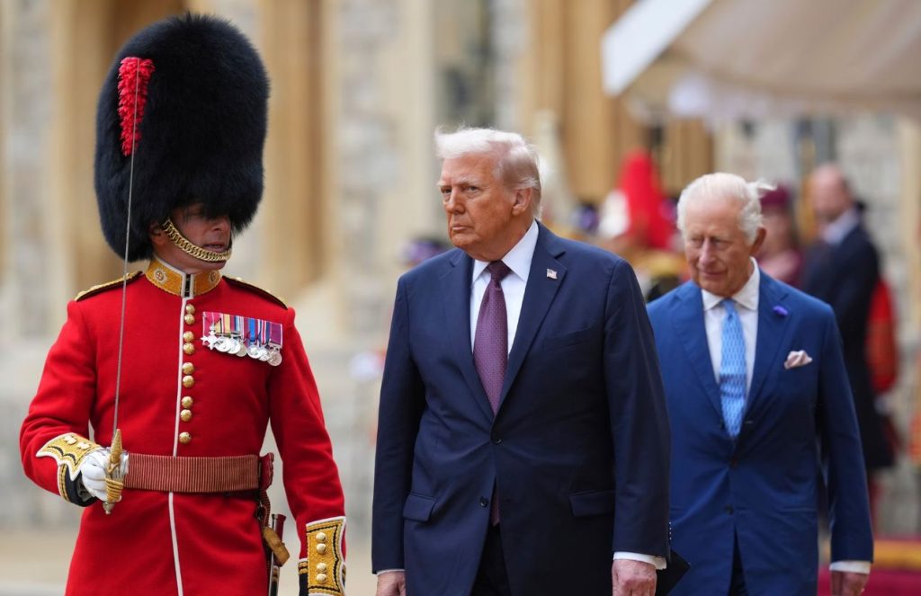 Trump walking on a red carpet accompanied by a classic United Kingdom soldier with a tall hat, while King Charles III follows closely behind