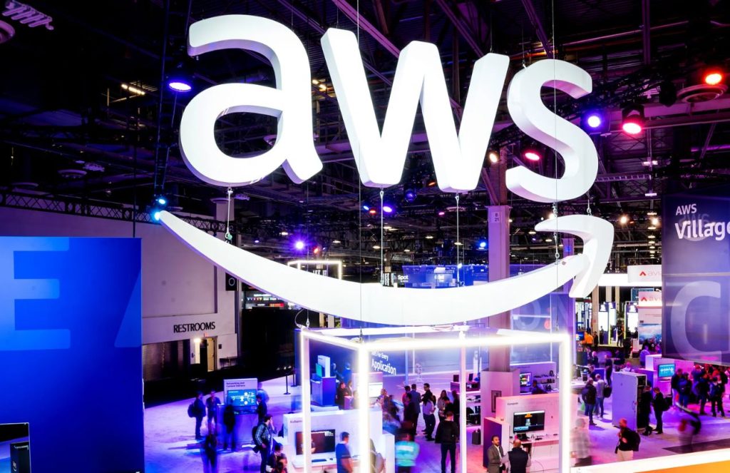 The initials of Amazon Web Services displayed at a technology company exhibition